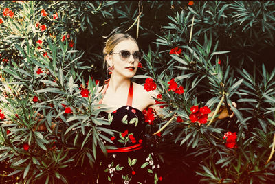 Woman wearing sunglasses amidst tree