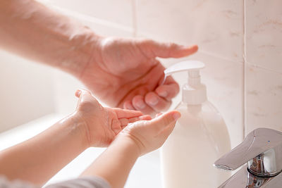 Close-up of hand holding hands at home