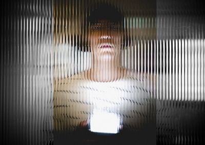 Woman seen through blinds