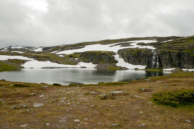 Scenic view of lake against sky during winter