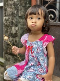 Portrait of cute girl holding camera