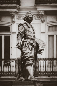 Low angle view of statue against building in city