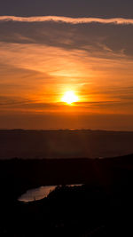 Scenic view of dramatic sky during sunset