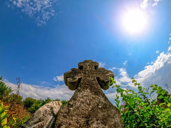 Medieval cross monument with carved inscription. ancient stone cross close up