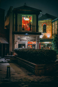 Illuminated building against sky at night