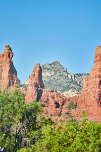 Rock formations on mountain against clear blue sky