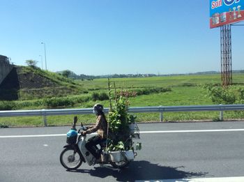 Side view of motorcycle on road against clear sky