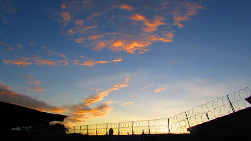 Low angle view of cloudy sky at sunset