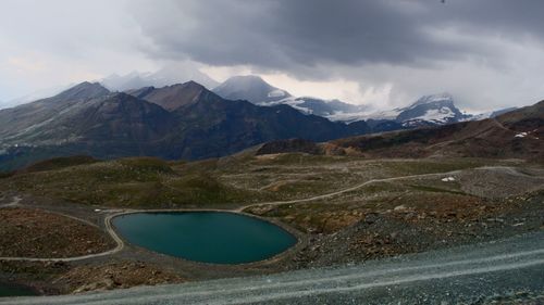 Scenic view of mountains against cloudy sky