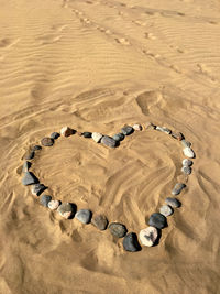 High angle view of stones arranged in heart shape on and
