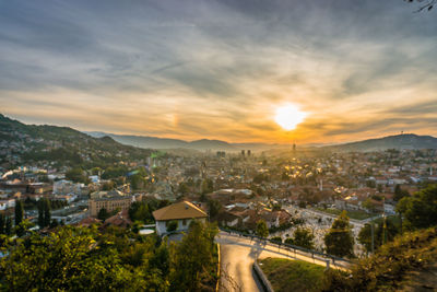 High angle view of illuminated buildings against sky at sunset