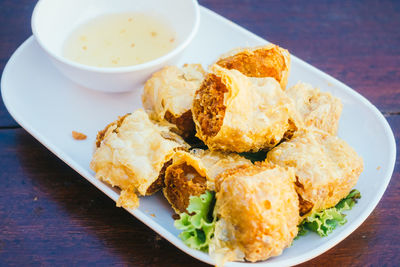 Close-up of spring roll in plate on table