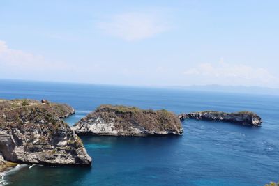 Scenic view of rocks in sea against sky