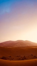 Scenic view of desert against sky during sunset