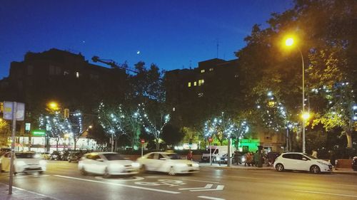 Cars on city street at night