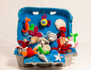 Close-up of toys on table against white background