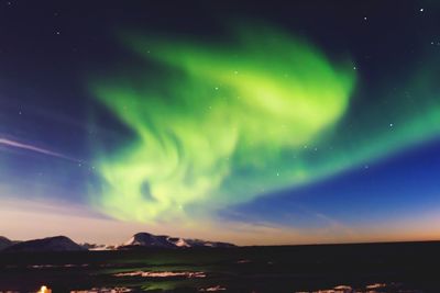 Scenic view of landscape against sky at night