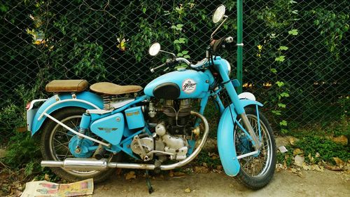 Motor scooter parked against blue sky