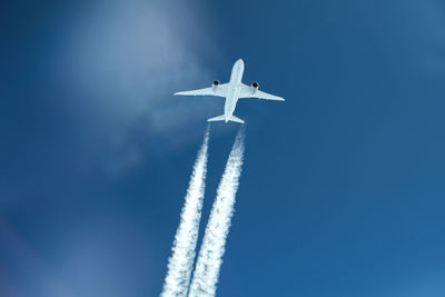 Low angle view of airplane against sky