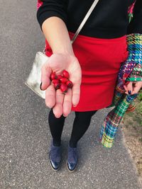 Low section of woman standing on street