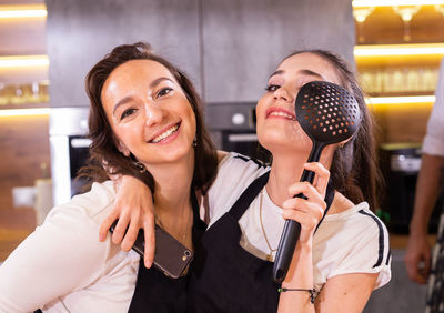 Portrait of young woman holding microphone