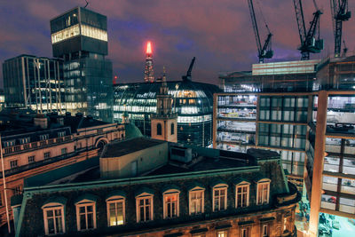 Low angle view of buildings against sky at night