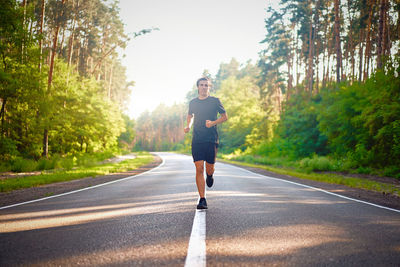 Full length of man running on road