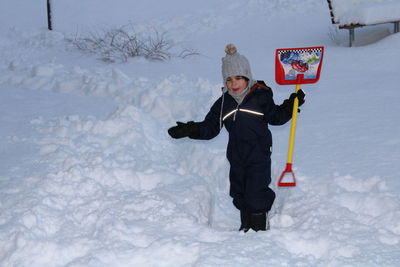 Portrait of boy standing on snow