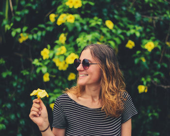 Young woman holding flower