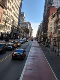 Vehicles on road along buildings