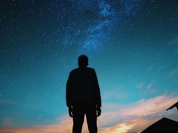 Rear view of man standing against sky