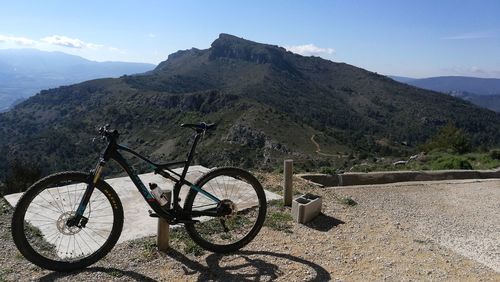 Bicycle on mountain against sky