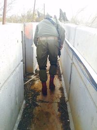 Rear view of man standing in snow