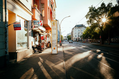Road amidst buildings against sky in city