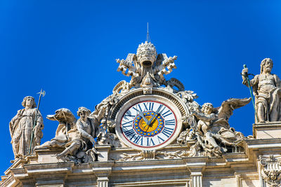 Low angle view of statue against blue sky