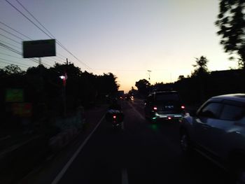 Cars on road at sunset