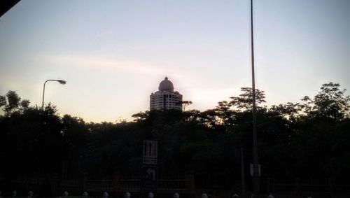 Low angle view of building against sky at sunset