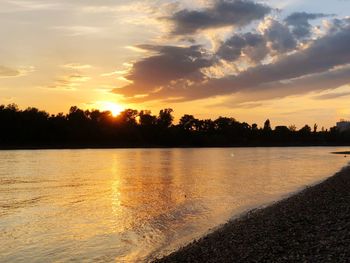 Scenic view of lake against orange sky