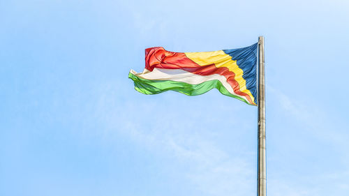 Colorful seychelles flag waving against clean blue sky