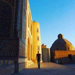 Full length of man amidst buildings against sky