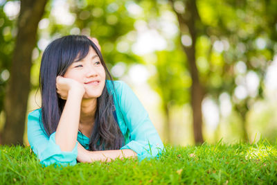 Portrait of a smiling young woman in grass