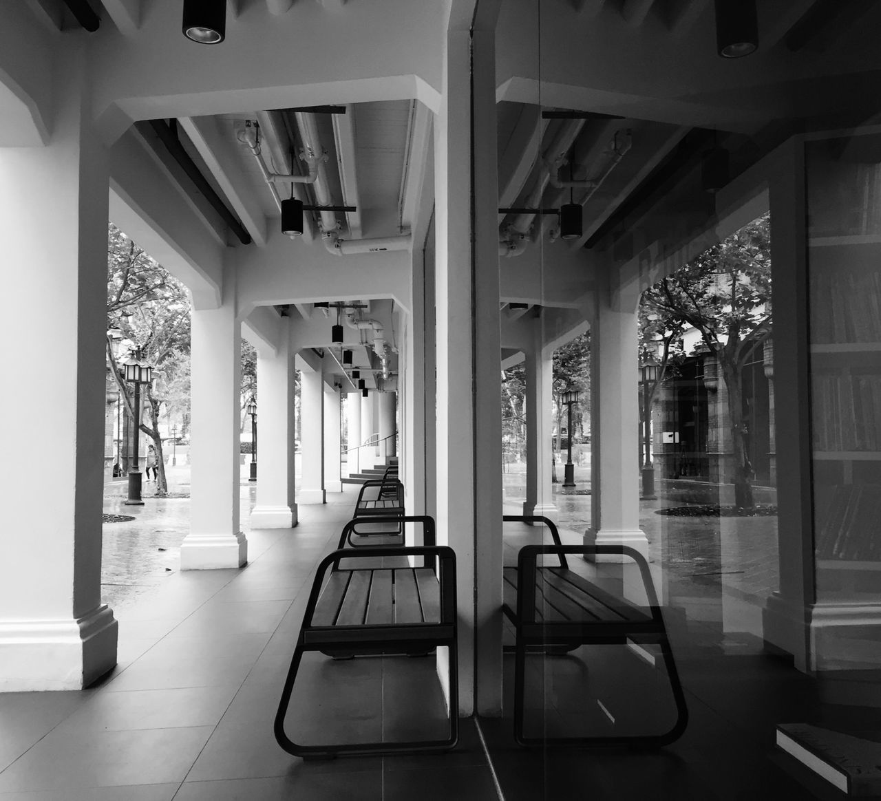 indoors, empty, absence, window, architecture, built structure, chair, corridor, interior, ceiling, seat, architectural column, flooring, the way forward, sunlight, column, day, in a row, transportation, glass - material