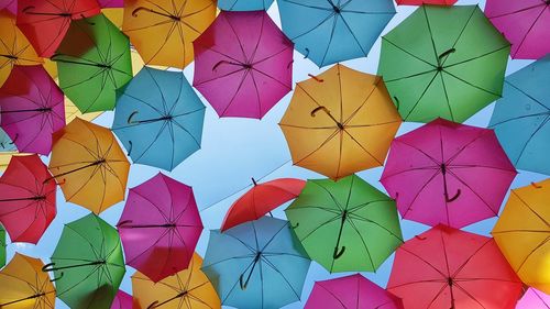Low angle view of multi colored umbrellas hanging on ceiling