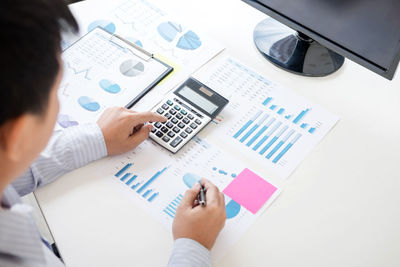 Cropped image of businessman working at desk in office