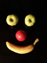 Close-up of apple against black background