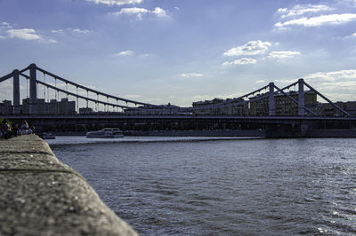 Bridge over river with buildings in background