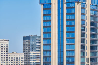 Low angle view of modern buildings against clear blue sky