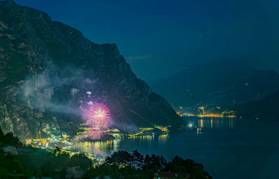 Scenic view of lake against sky at night