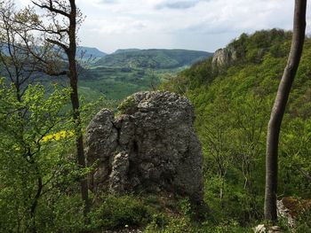Scenic view of rocks on land against sky