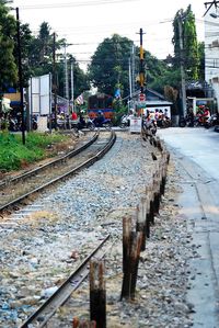 Railroad tracks by trees against sky